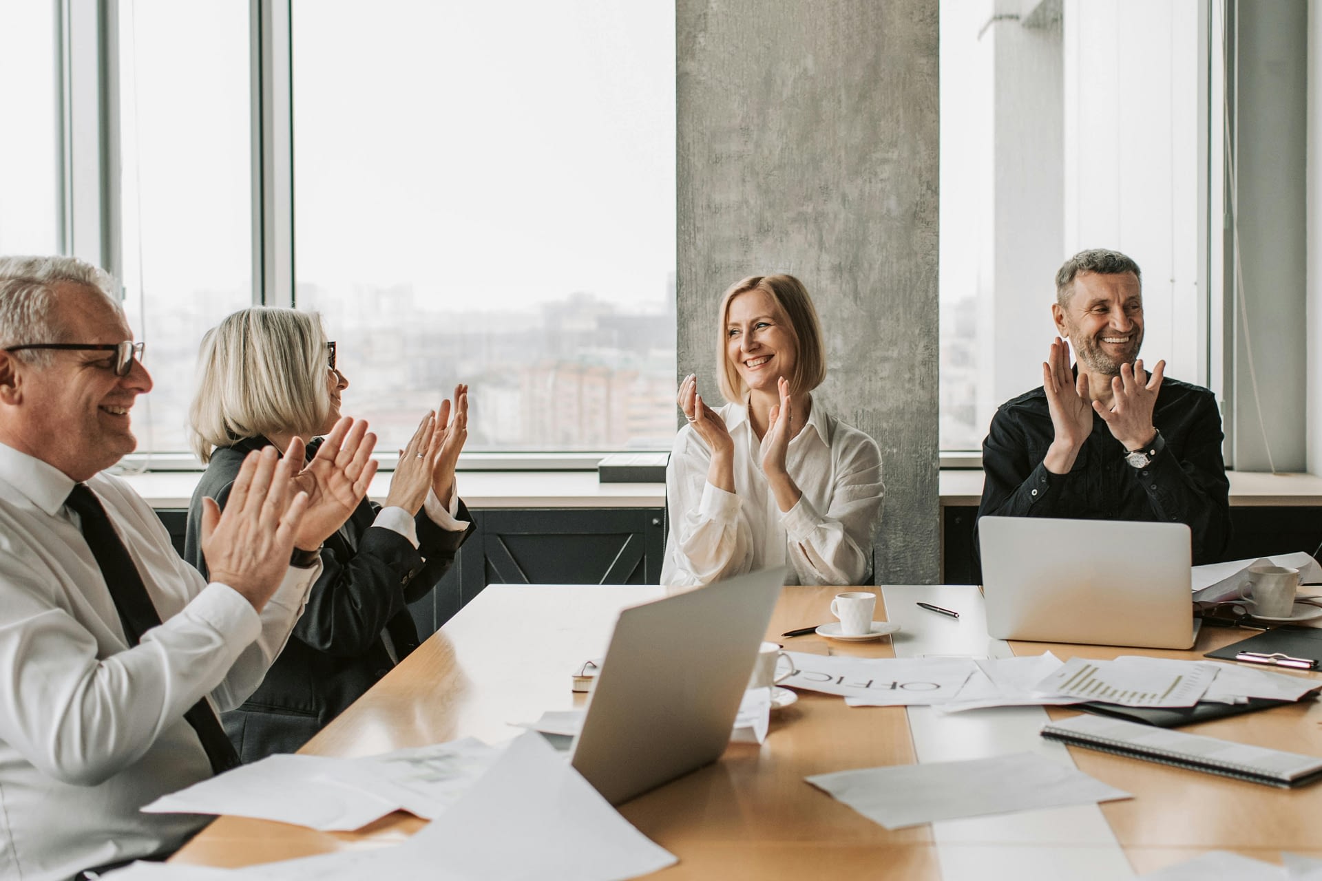 the power of mattering -- photo of adults clapping while smiling