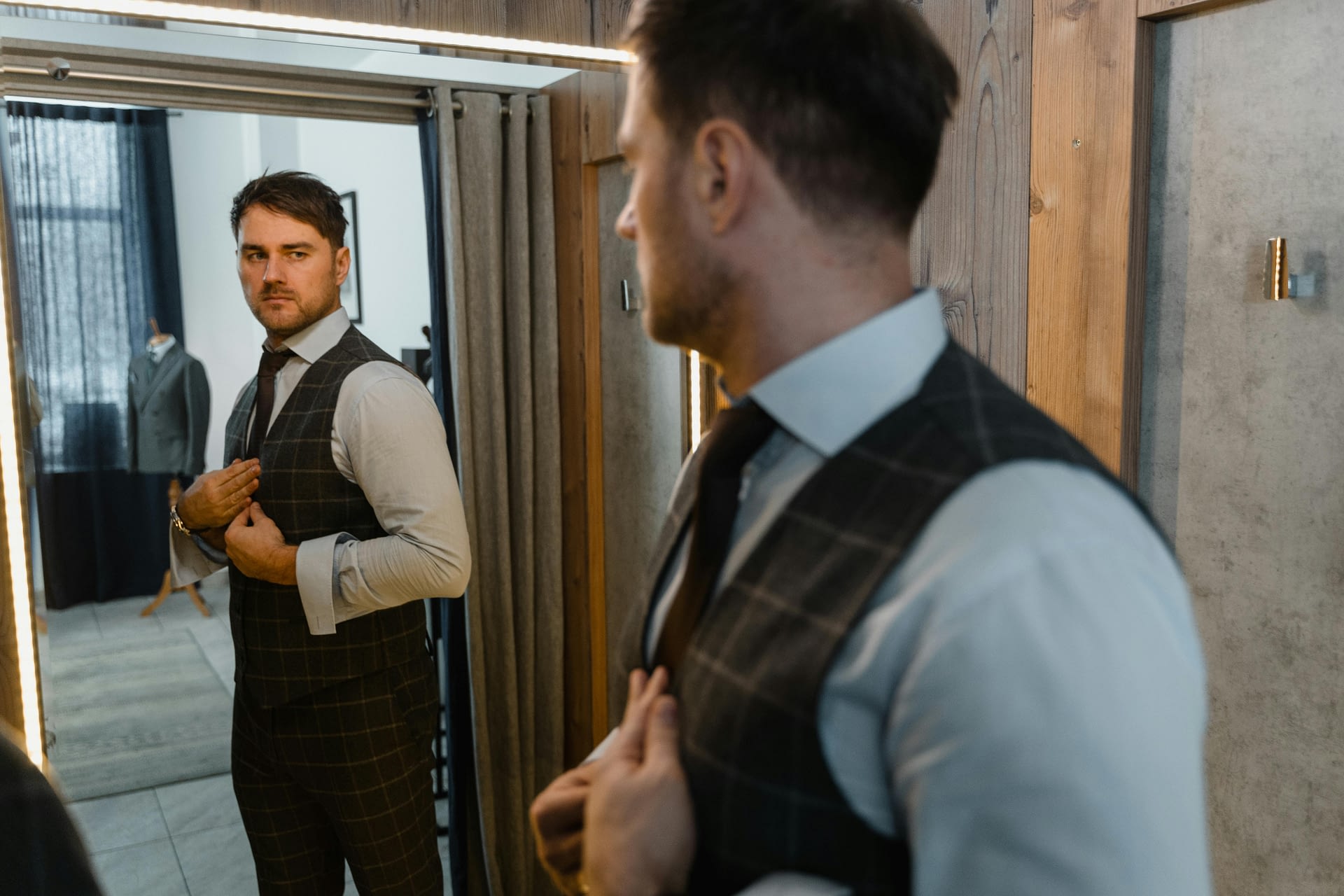 why identity recognition at work matters -- a man in a suit looking at his reflection