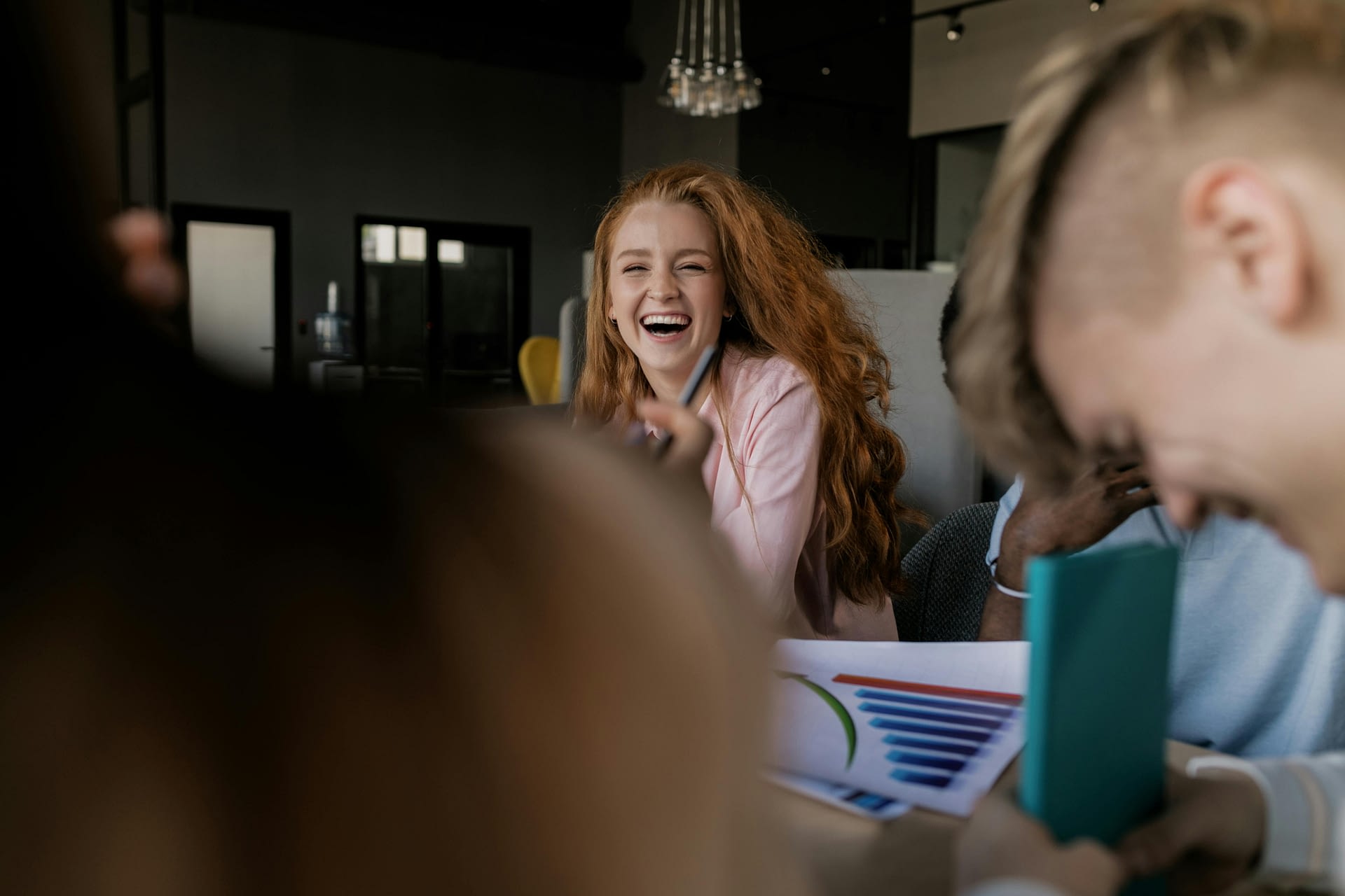high energy teams -- photograph of a woman with red hair laughing