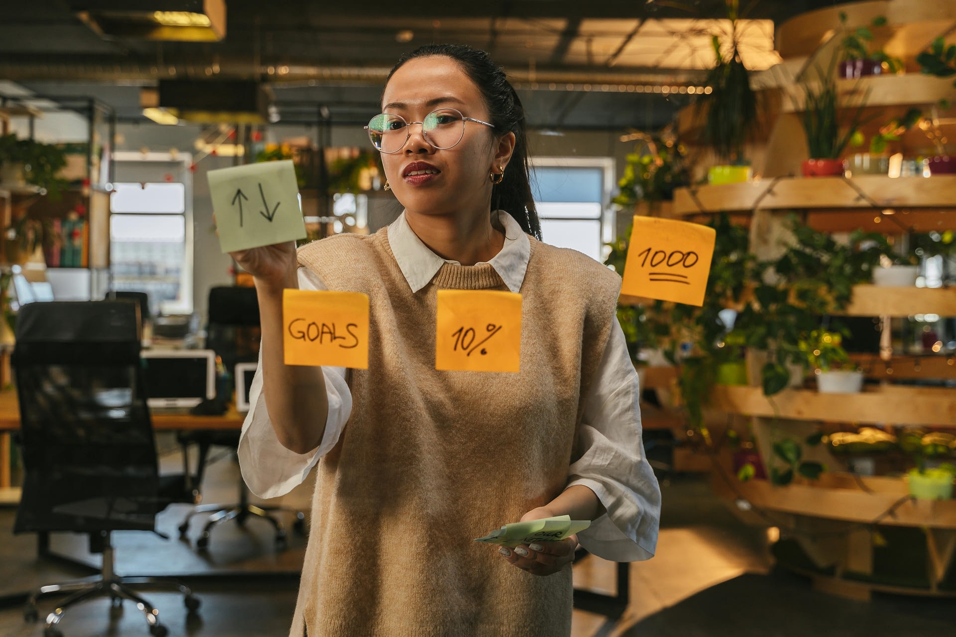why some goals stick -- a woman standing near the mirror with some sticky notes